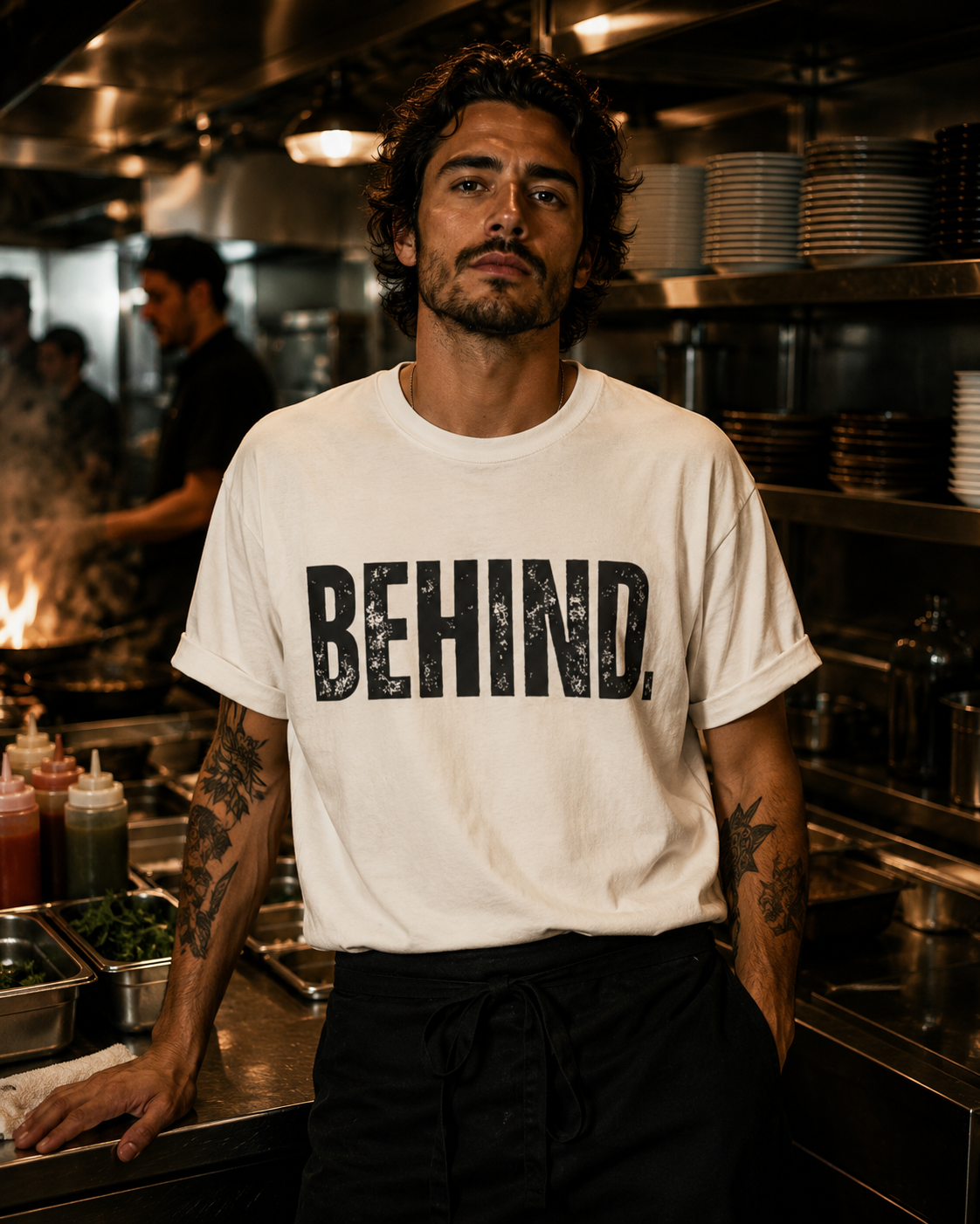 BEHIND. Tee